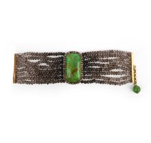 A hardstone, smoky quartz and diamond bracelet, centring on a plaque of green hardstone, within a