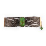 A hardstone, smoky quartz and diamond bracelet, centring on a plaque of green hardstone, within a