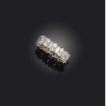 A diamond eternity ring, designed as a continuous band of baguette diamonds spaced by pairs of