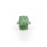 An Art Deco jadeite and diamond ring, 1920s, claw-set with a rectangular jadeite carved with fruit