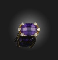 An amethyst and diamond ring, set with an oval faceted amethyst within diamond surround in 18ct
