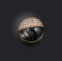 Cartier, a diamond bombe ring, of hemispherical design, half formed of black jade, the other half
