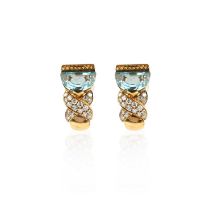 A pair of blue topaz and diamond earrings, each set with a demilune blue topaz, above crossed motifs