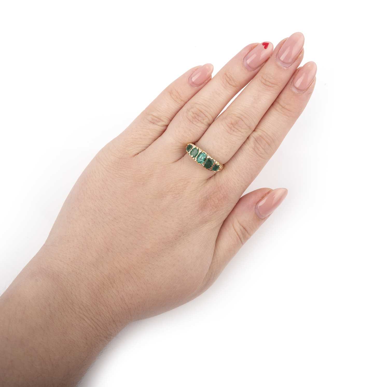 An emerald and diamond ring, set with oval emeralds, spaced by small single-cut diamonds, to a - Image 2 of 2