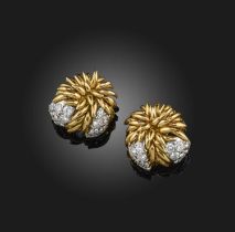 A pair of gold and diamond ear clips, France, 1970s, each of foliate design, composed of leaf motifs