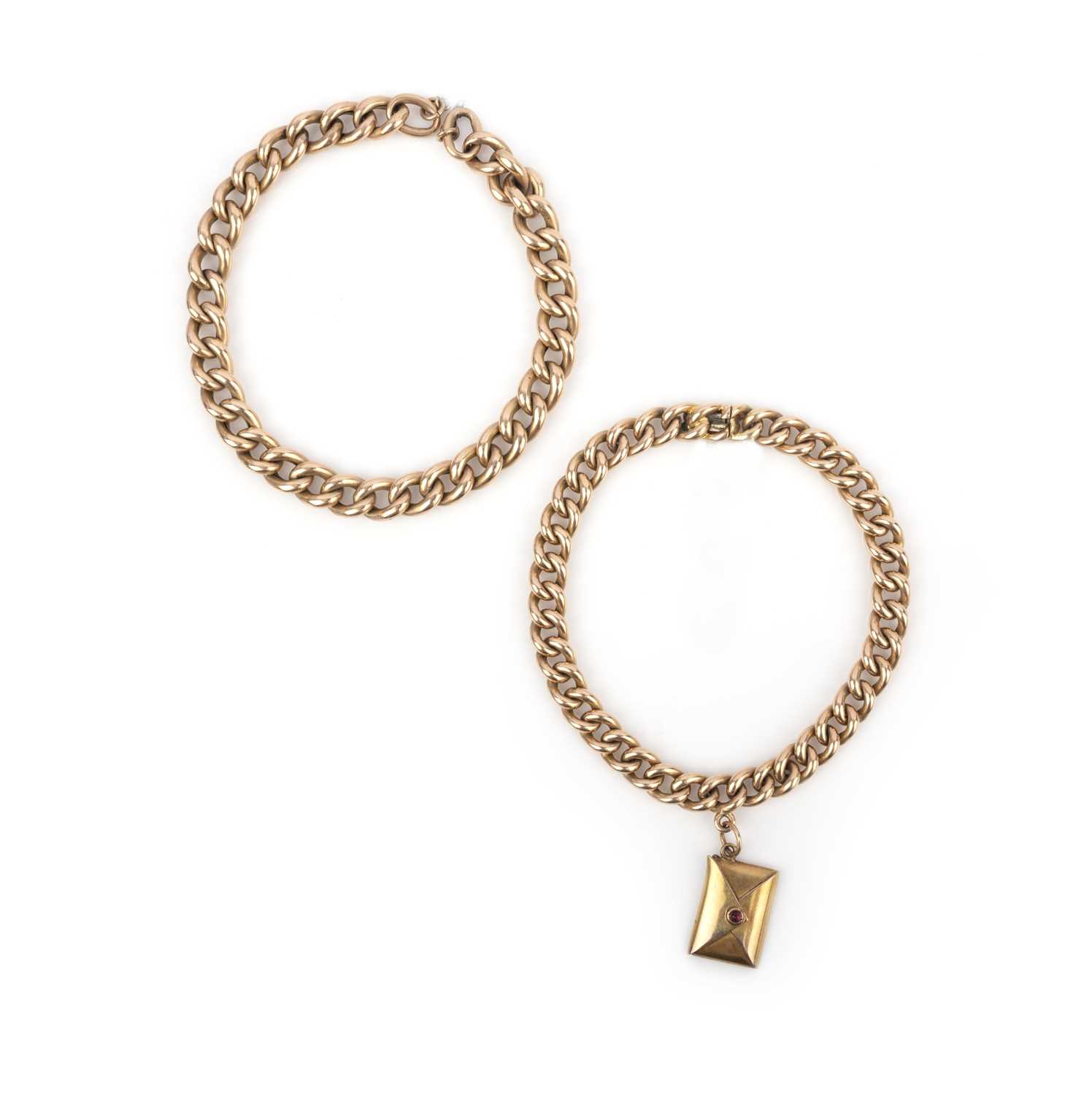 Two gold bracelets, circa 1900, each of curb linking, one suspending a charm designed as an envelope