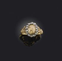 An agate and diamond ring, early 19th century, of cluster design, set with a cabochon agate within a