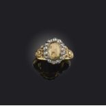 An agate and diamond ring, early 19th century, of cluster design, set with a cabochon agate within a