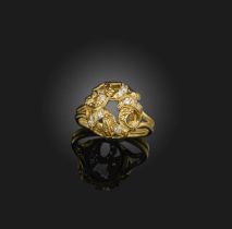 Φ Φ John Donald, an abstract diamond ring, of textured scroll design set with circular-cut