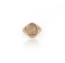 A gold signet ring, carved with the crest of a goat passant, in 9ct gold, size K1/2, British