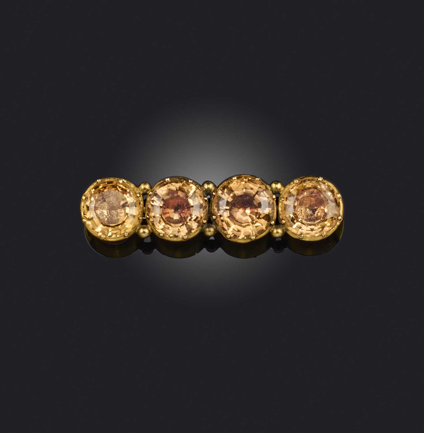 George III and later, a topaz bar brooch, set with four circular-cut topaz in closed-back yellow