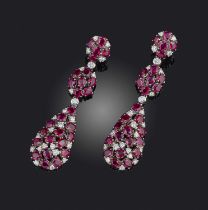A pair of ruby and diamond earrings, each of pendent design, composed of three sections set with
