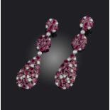 A pair of ruby and diamond earrings, each of pendent design, composed of three sections set with