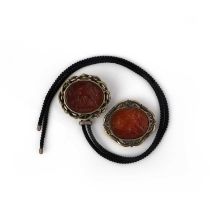 Two carnelian intaglio brooches, comprising two brooches, each set with an oval carnelian intaglio