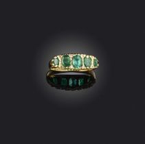 An emerald and diamond ring, set with oval emeralds, spaced by small single-cut diamonds, to a