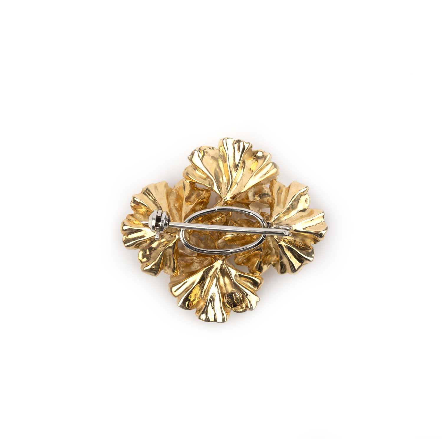 A gold, emerald and ruby brooch, Italy, 1970s, designed as four abstract flowers in textured gold, - Image 2 of 2