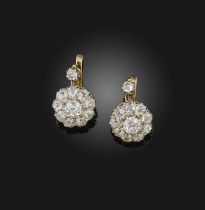 A pair of diamond earrings, circa 1900, each suspending a cluster of cushion-shaped diamonds,