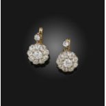 A pair of diamond earrings, circa 1900, each suspending a cluster of cushion-shaped diamonds,