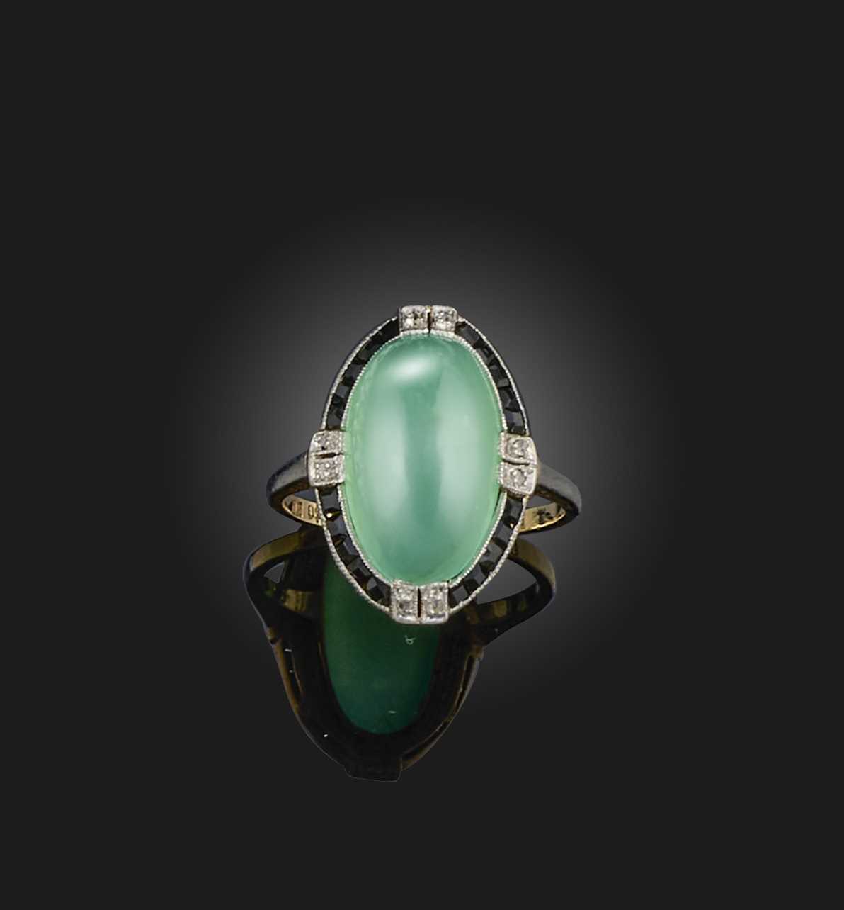 An Art Deco chrysoprase, onyx and diamond ring, 1920s, set with a chrysoprase cabochon, within a