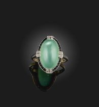 An Art Deco chrysoprase, onyx and diamond ring, 1920s, set with a chrysoprase cabochon, within a