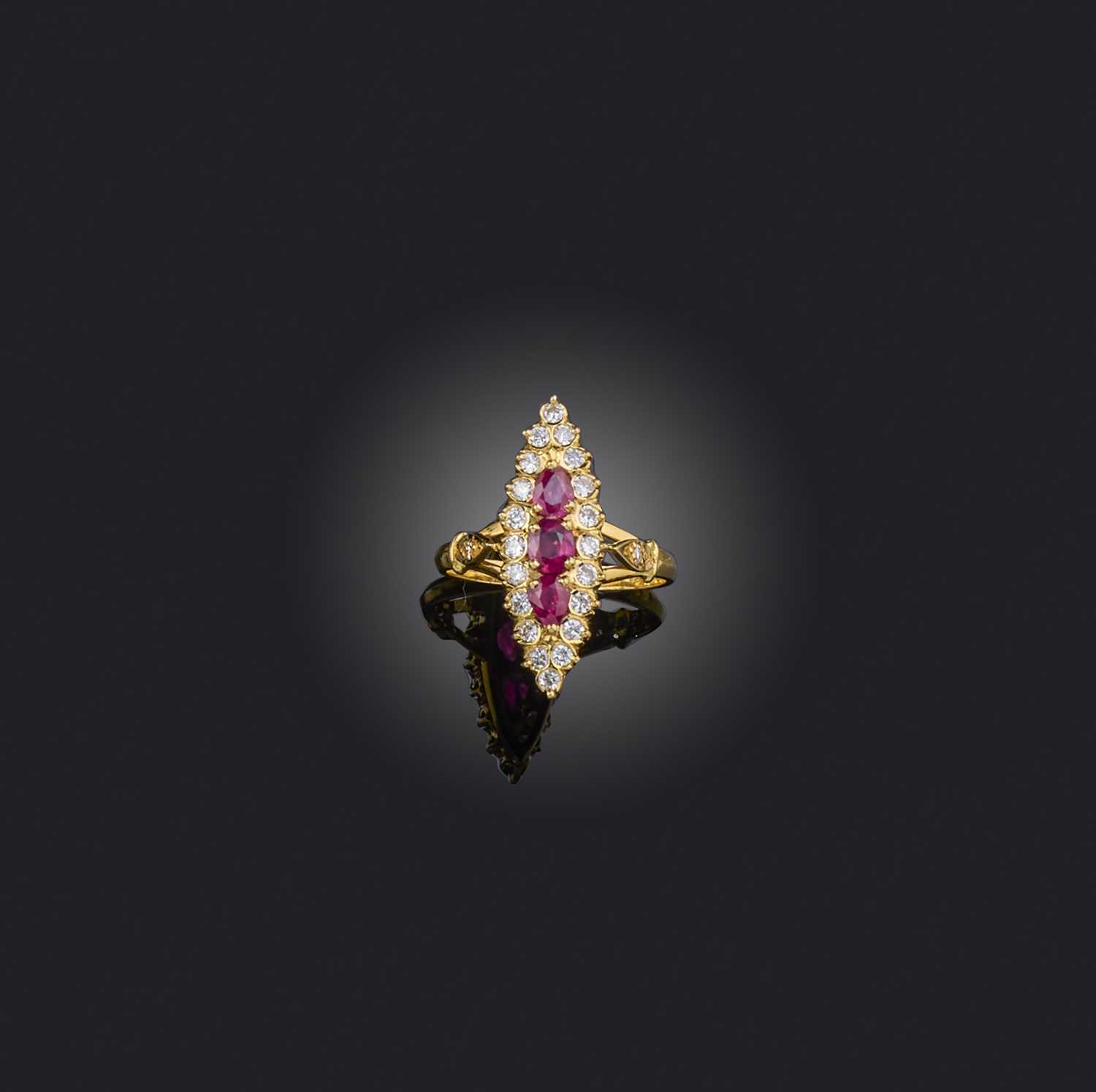 A ruby and diamond navette-shaped ring, set with graduated rubies within a diamond border in