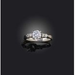 A diamond ring, set with a brilliant-cut diamond weighing approximately 0.60 carats, to shoulders