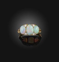 An opal and diamond ring, late 19th century, the oval opals mounted in a carved and pierced yellow