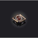 A diamond-set gold eye ring, the eye set within a surround of diamonds in gold, size J