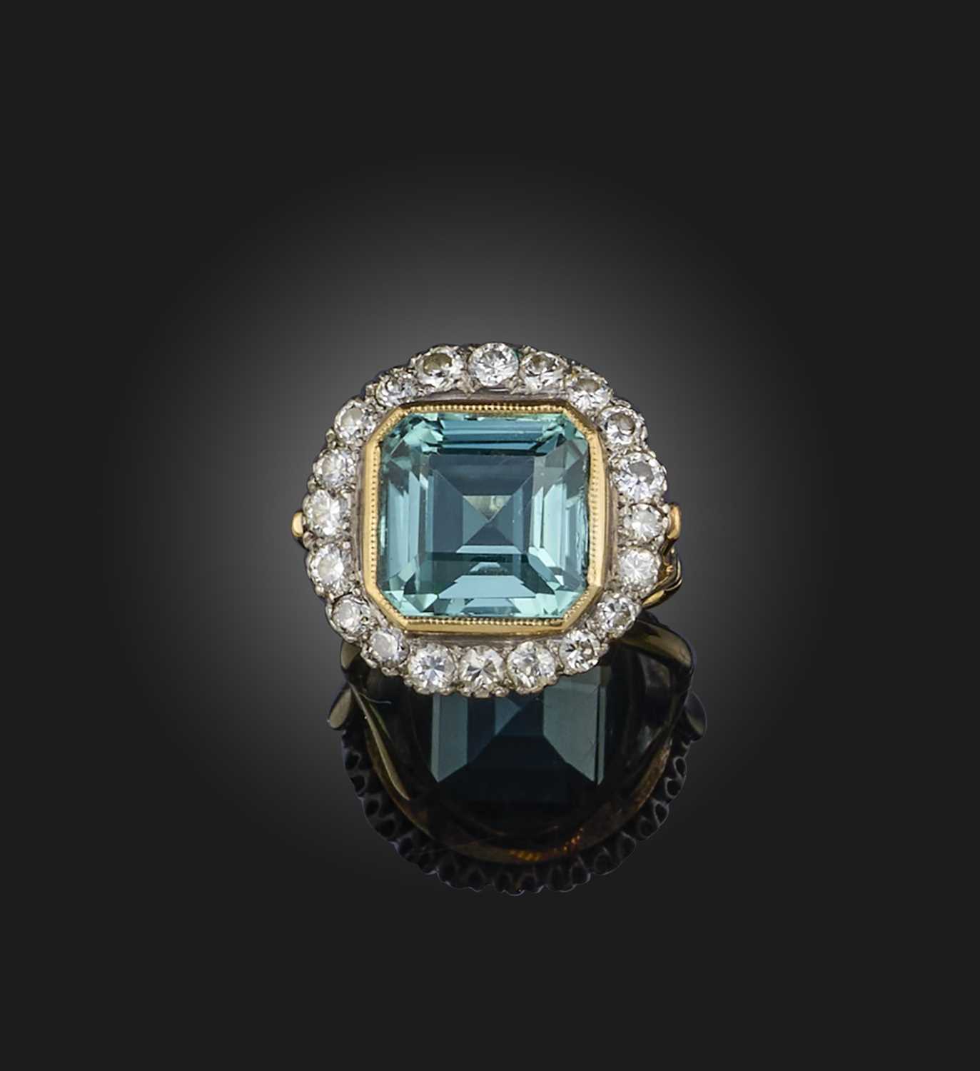 A blue tourmaline and diamond cluster ring, the square step-cut tourmaline set within a surround