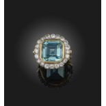 A blue tourmaline and diamond cluster ring, the square step-cut tourmaline set within a surround