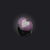 A pink sapphire and diamond heart ring, of bombe form, the heart formed of circular-cut diamonds