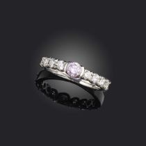 A pink and colourless diamond ring, the pink diamond weighing approximately 0.30cts, within