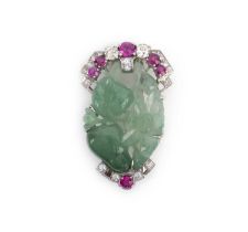 A jadeite, ruby and diamond brooch, mid 20th century, set with a section of jadeite carved with