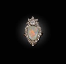 An opal and diamond ring, designed as a flaming heart motif, set with a pear-shaped cabochon opal