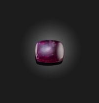 † † A loose sugarloaf cabochon ruby, weighing 3.47cts A verbal report from GCS states that the