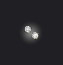 A pair of diamond stud earrings, each claw-set with a brilliant-cut diamond, total diamond weight