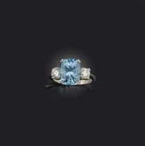 An aquamarine and diamond ring, claw-set with a cushion-shaped aquamarine weighing approximately 4.