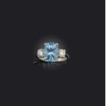 An aquamarine and diamond ring, claw-set with a cushion-shaped aquamarine weighing approximately 4.