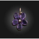 An early 20th century amethyst flower brooch / pendant, set with five matched oval amethysts