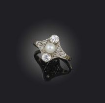 An Art Deco pearl and diamond ring, set with a pearl flanked with old circular-cut diamonds within