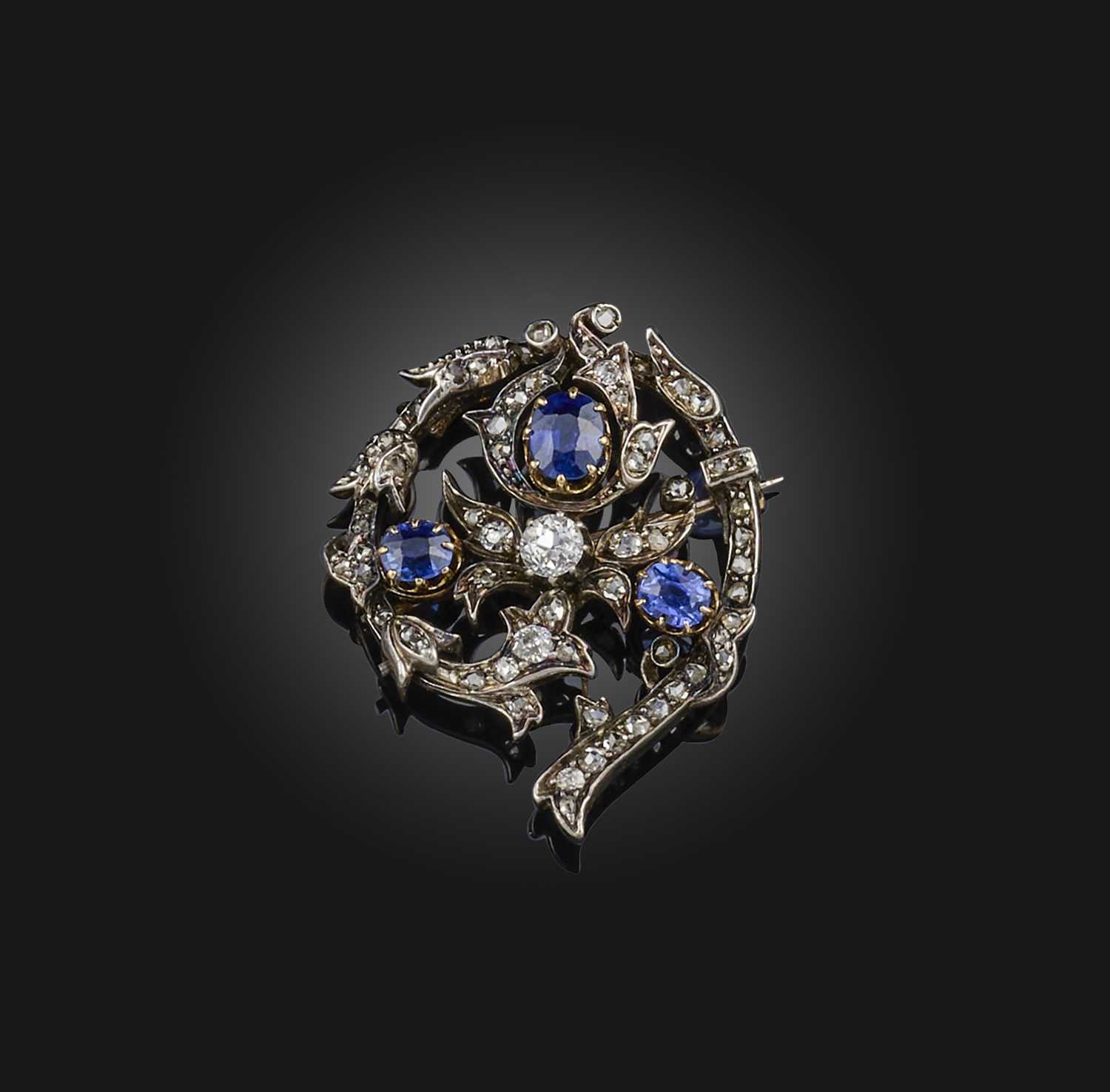 A Victorian sapphire and diamond brooch, late 19th century, designed as a foliate spiral, set with - Image 2 of 3