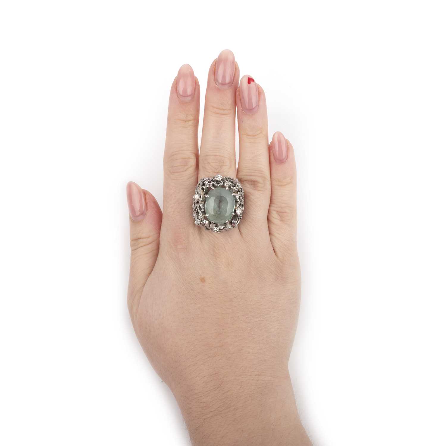 An aquamarine & diamond ring, 1970s, set with a cushion-shaped aquamarine, within an abstract - Image 2 of 2