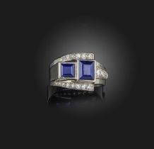 An Art Deco sapphire and diamond ring, circa 1930, of stylised buckle design, set with two