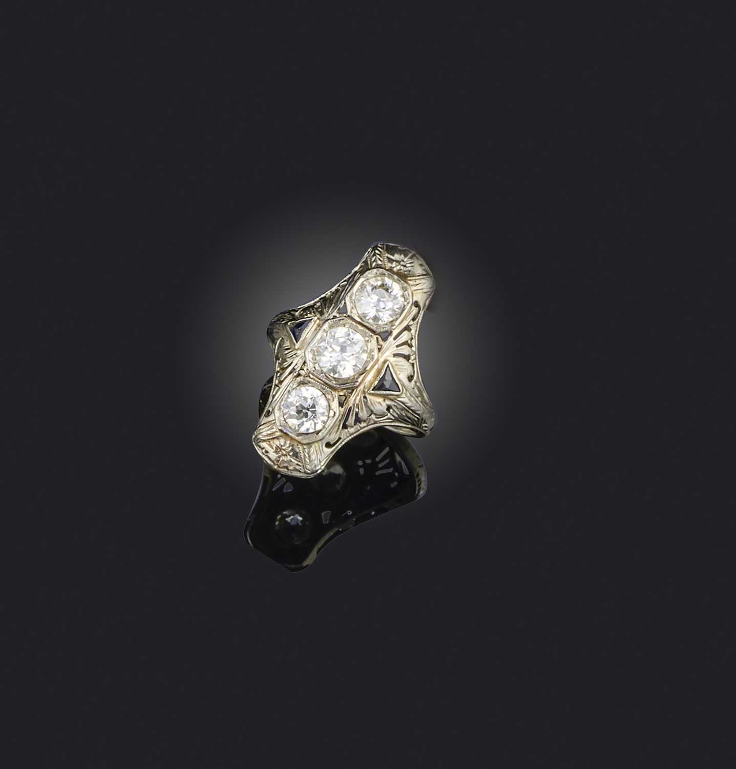 A diamond ring, early 20th century, set with a vertical line of circular-cut diamonds totalling