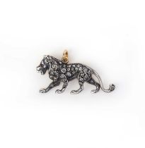 A diamond and ruby pendant, designed as a lion, set with rose-cut diamonds totalling approximately