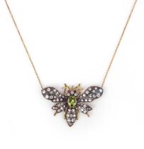 A peridot and diamond bee pendant, set with graduated diamonds and ruby eyes with an oval peridot