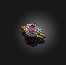 A ruby and diamond cluster ring, set with a cushion-shaped ruby within a rose-cut diamond