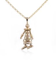A gold and gem-set pendant necklace, designed as a clown, set with circular-cut gemstones and