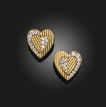Cartier, a pair of gold and diamond earrings, 1970s, each designed as a gold heart engraved with