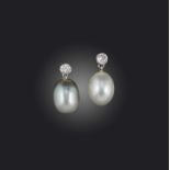 A pair of natural pearl and diamond earrings, each set with a circular-cut diamond suspending a